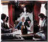 Yvon at the head of the table, looking over military plans ~ Parks Canada, Fortress of Louisbourg