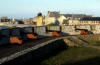 Cannons overlooking the harbour of the partially (1/5th) reconstructed town of Louisbourg � Parks Canada / Parcs Canada